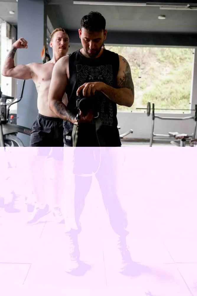 Trainer helping a member get set up