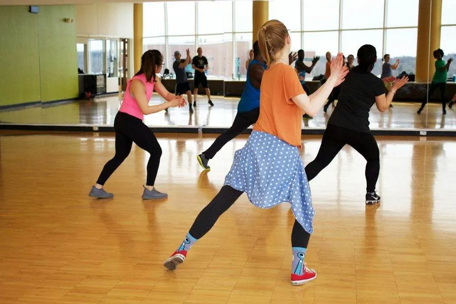 Women dancing in front of a studio mirror